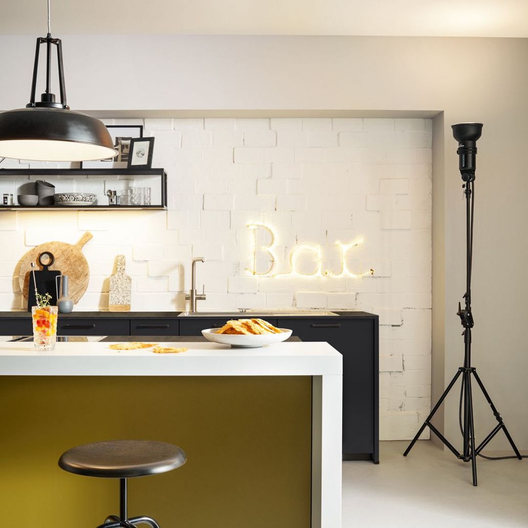 modern black kitchen with olive yellow cooking island