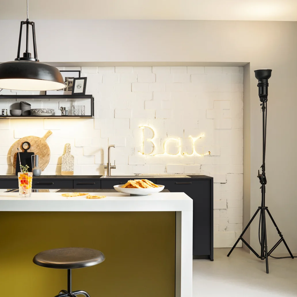 modern black kitchen with olive yellow cooking island